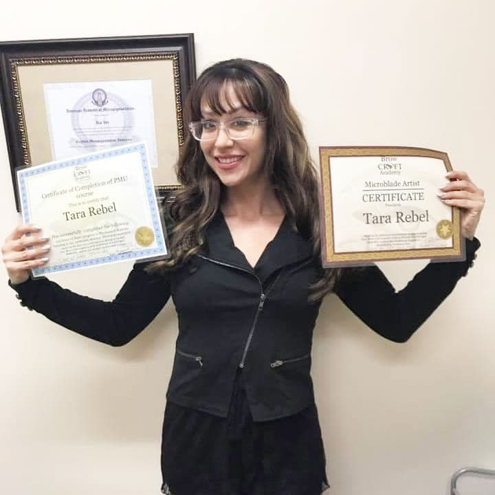 Tara Rebel displaying her professional certification at Rebel Aesthetics in New Jersey.