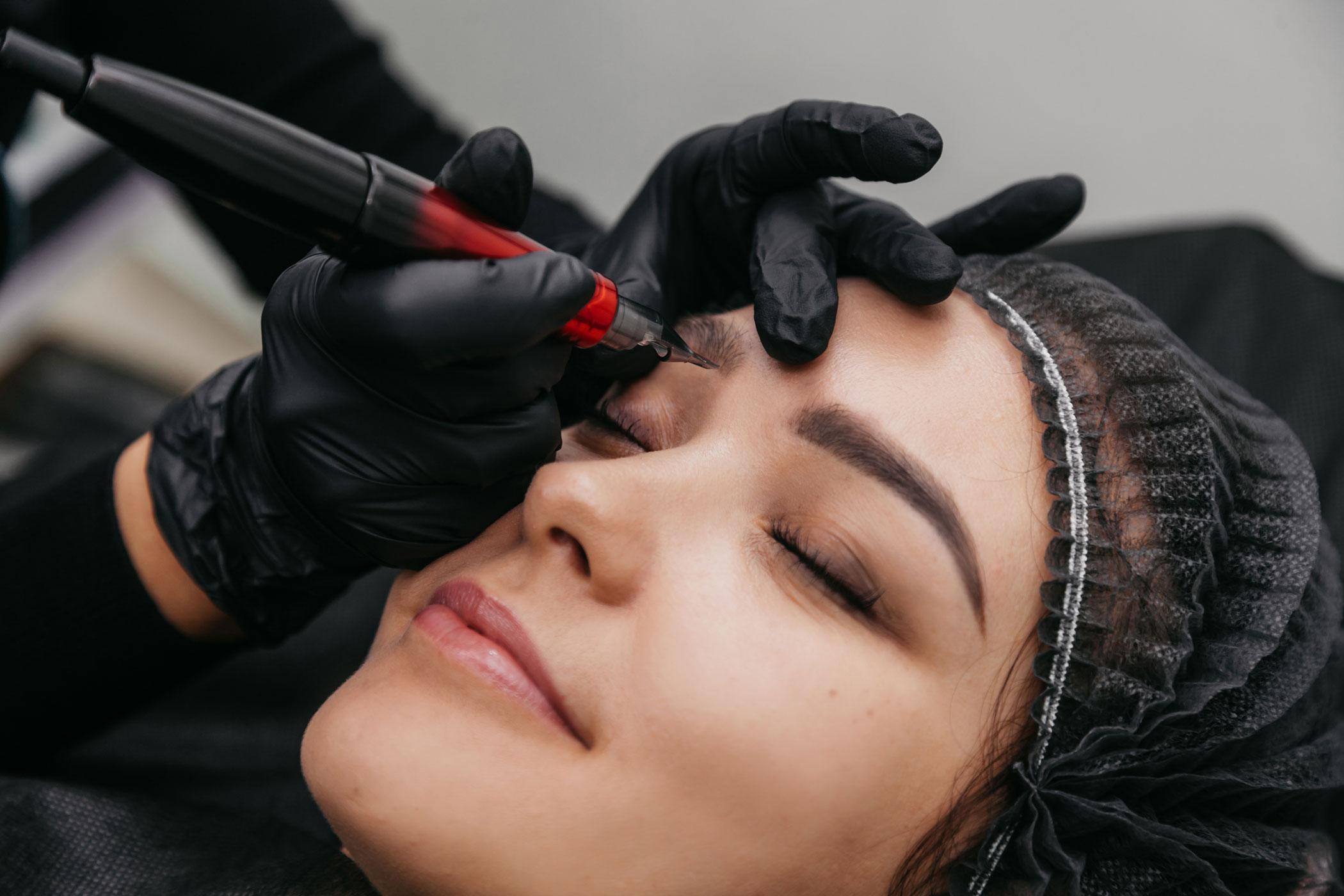 Artist working on a client's eyebrows