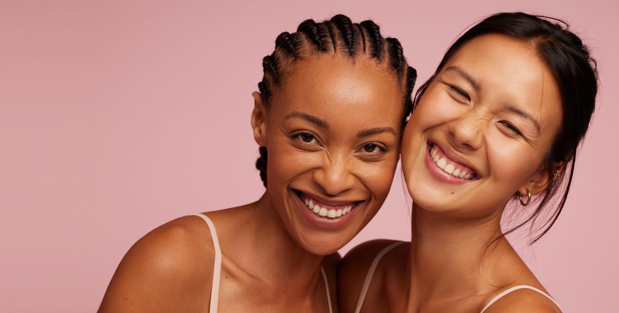 Two smiling women with clear skin