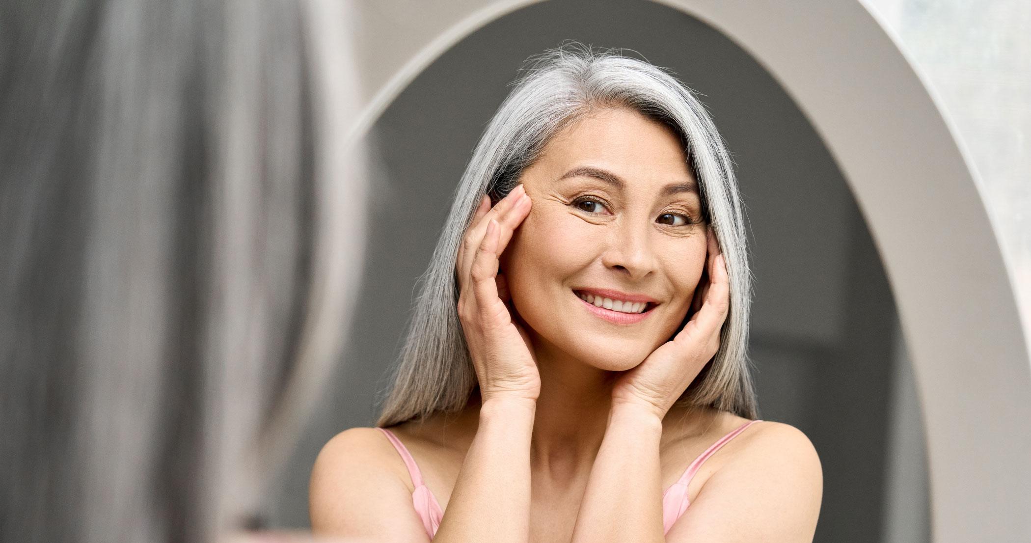 Smiling woman with silver hair and soft makeup