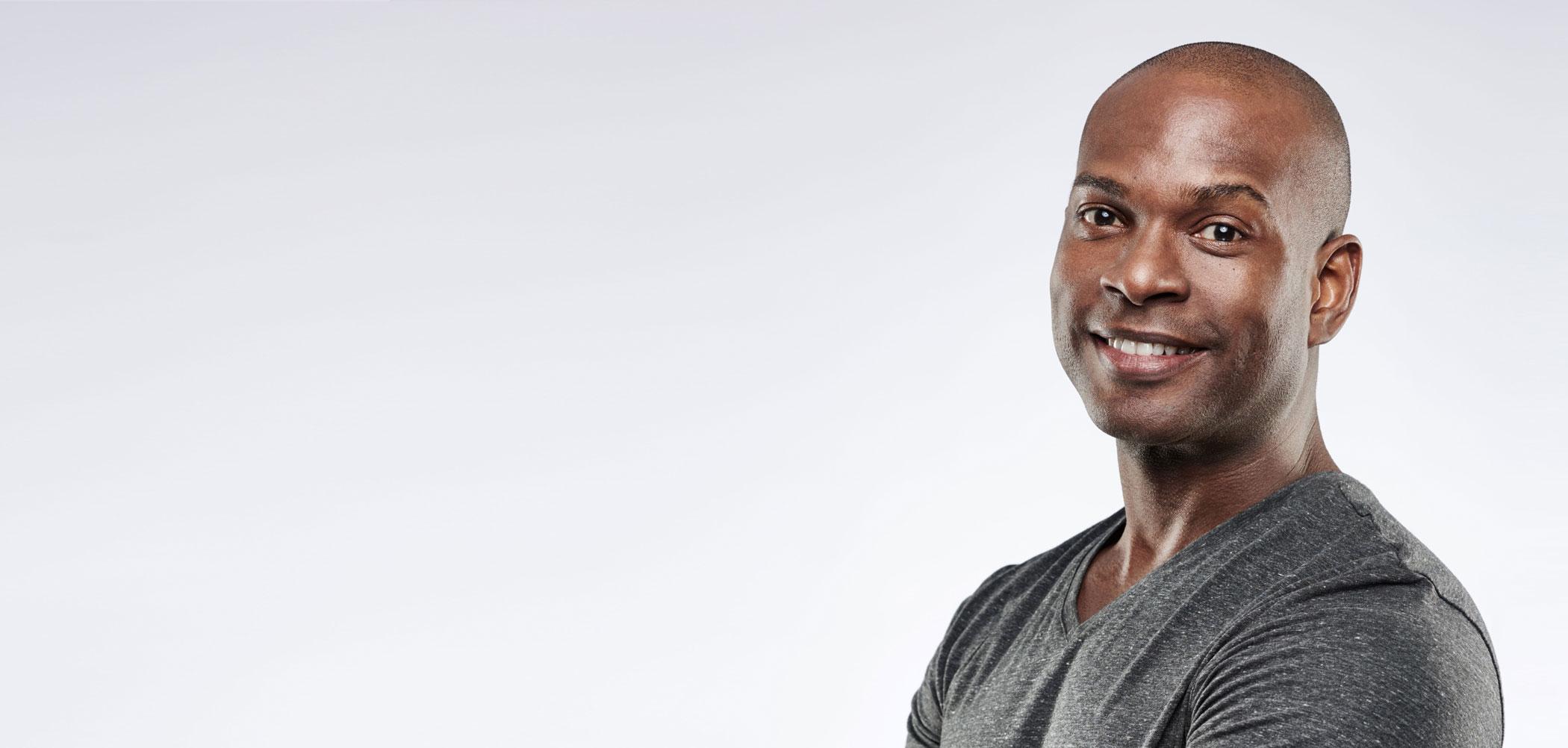 Smiling man with a shaved head