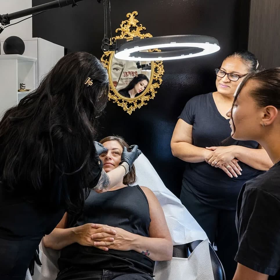 Tara Rebel teaching students during a permanent makeup class